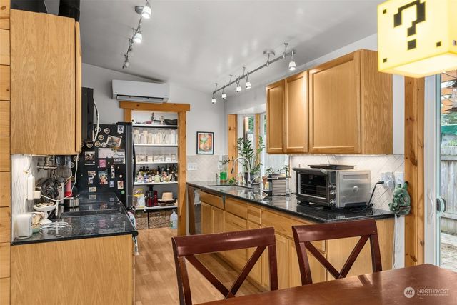 a kitchen with stainless steel appliances granite countertop a sink refrigerator and microwave