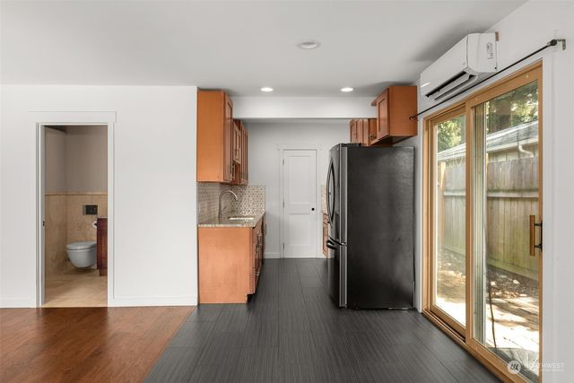 a kitchen with granite countertop stainless steel appliances and wooden cabinets