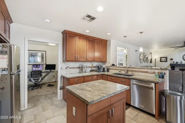 a kitchen with stainless steel appliances granite countertop sink stove and dining table