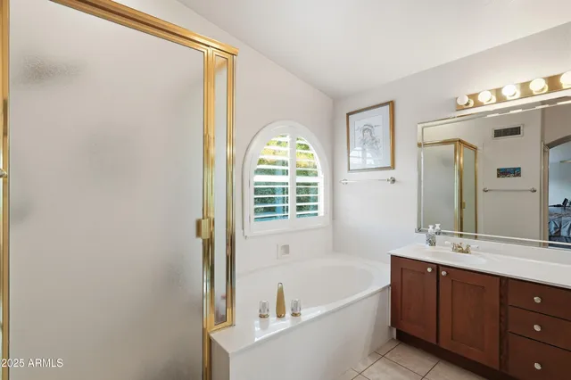 a bedroom with a bed a couch and window