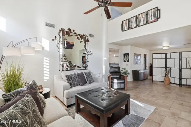 a front view of a house with a yard and potted plants