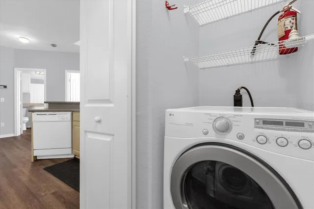 a view of washer and dryer with kitchen in the background