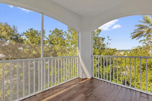 a view of a balcony with lake view and wooden floor