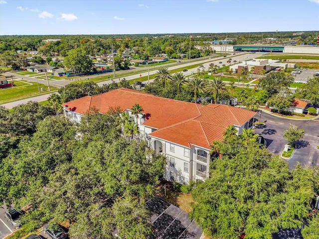 an aerial view of residential houses with outdoor space and lake view