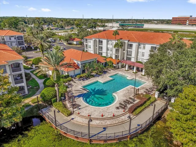an aerial view of a house with a yard and lake view