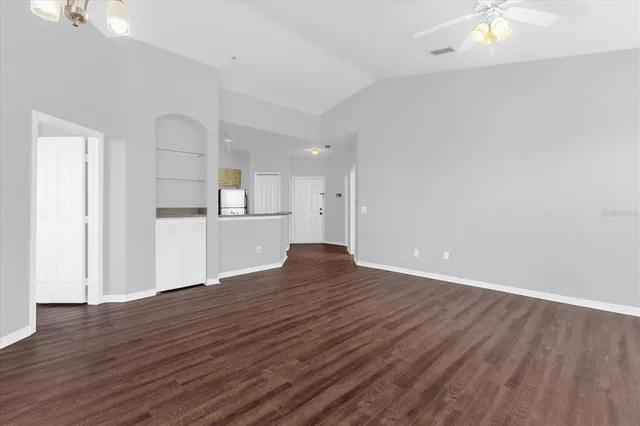 a view of a kitchen with wooden floor and a sink