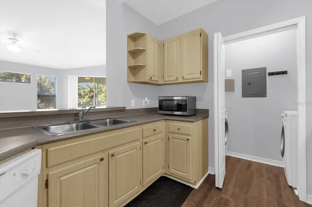 a kitchen with cabinets appliances and a sink