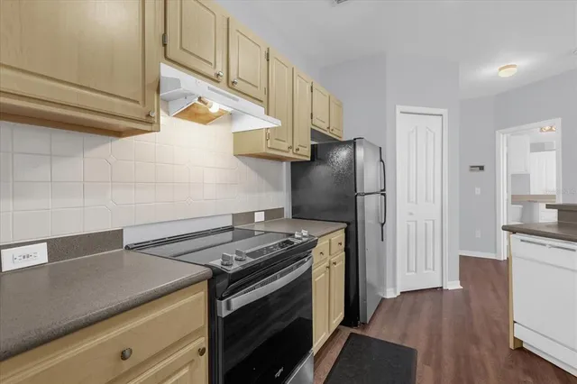 a kitchen with a stove and a refrigerator