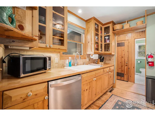 a kitchen with stainless steel appliances kitchen island granite countertop a sink and a microwave