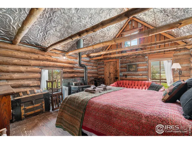 a bedroom with a bed a chandelier and a window