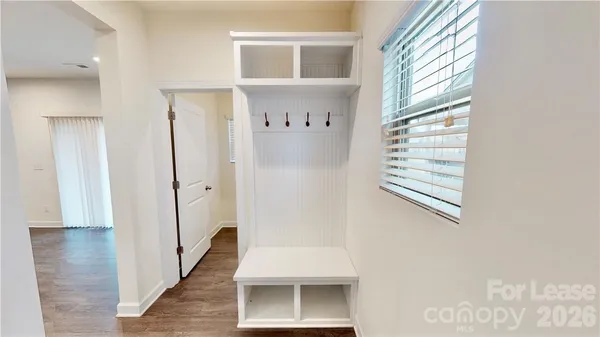 a view of an entryway with wooden floor