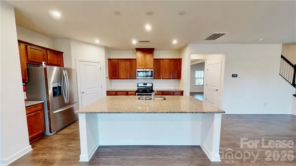 a large kitchen with stainless steel appliances lots of counter top space