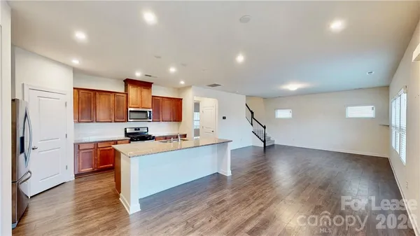 a kitchen view with stainless steel appliances a refrigerator and a stove top oven