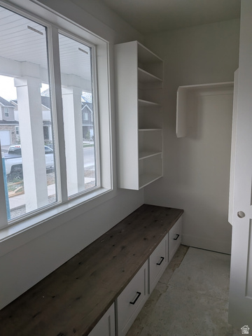 2771 West Aurora Avenue Mapleton, UT 84664 - Photo 19 of 39 Mudroom featuring built-in white cabinetry with a wood-finish countertop, black hardware, and shelving