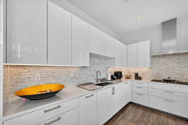 a kitchen with granite countertop white cabinets and white appliances