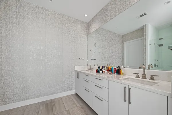 a spacious bathroom with a shower sink and mirror