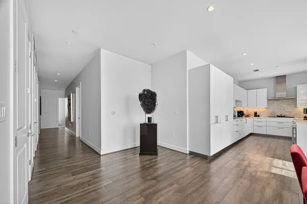 a kitchen with white cabinets and white appliances