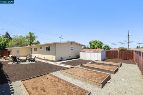 a backyard of a house with table and chairs