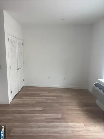 a view of an empty room and wooden floor