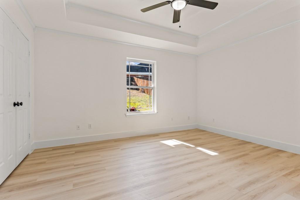 804 Alta Street Longview, TX 75604 - Photo 12 of 20 wooden floor in an empty room with a window