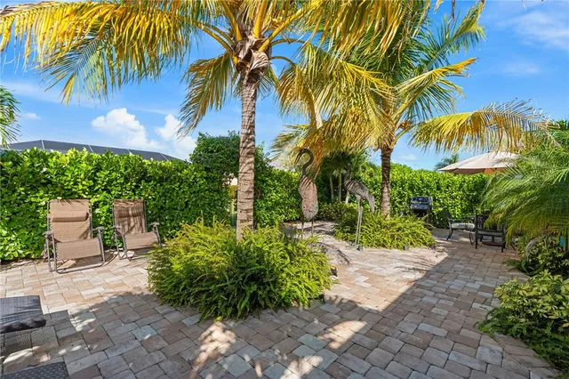 a view of backyard with swimming pool and outdoor seating
