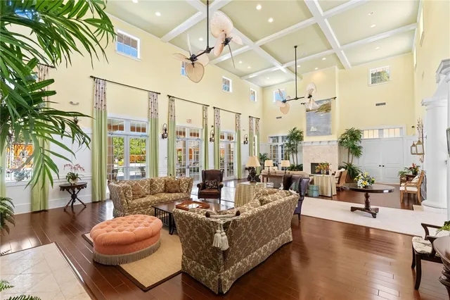 a living room with patio furniture and a potted plants