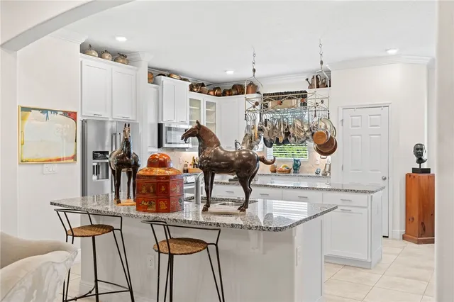 a kitchen with stainless steel appliances granite countertop a sink and cabinets
