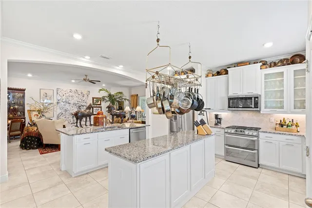a view of a dining room and livingroom with furniture wooden floor a chandelier