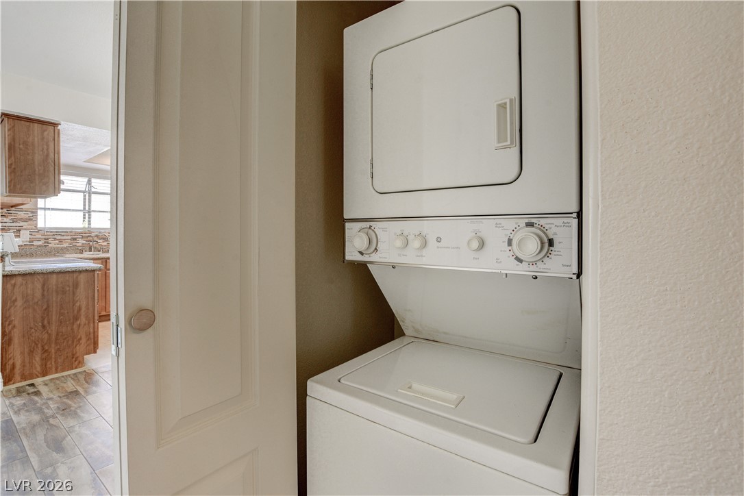 7200 West Pirates Cove Road, Unit 1026 Las Vegas, NV 89145 - Photo 16 of 35 This compact laundry area offers convenient and efficient clothes care, seamlessly integrating into your living space.