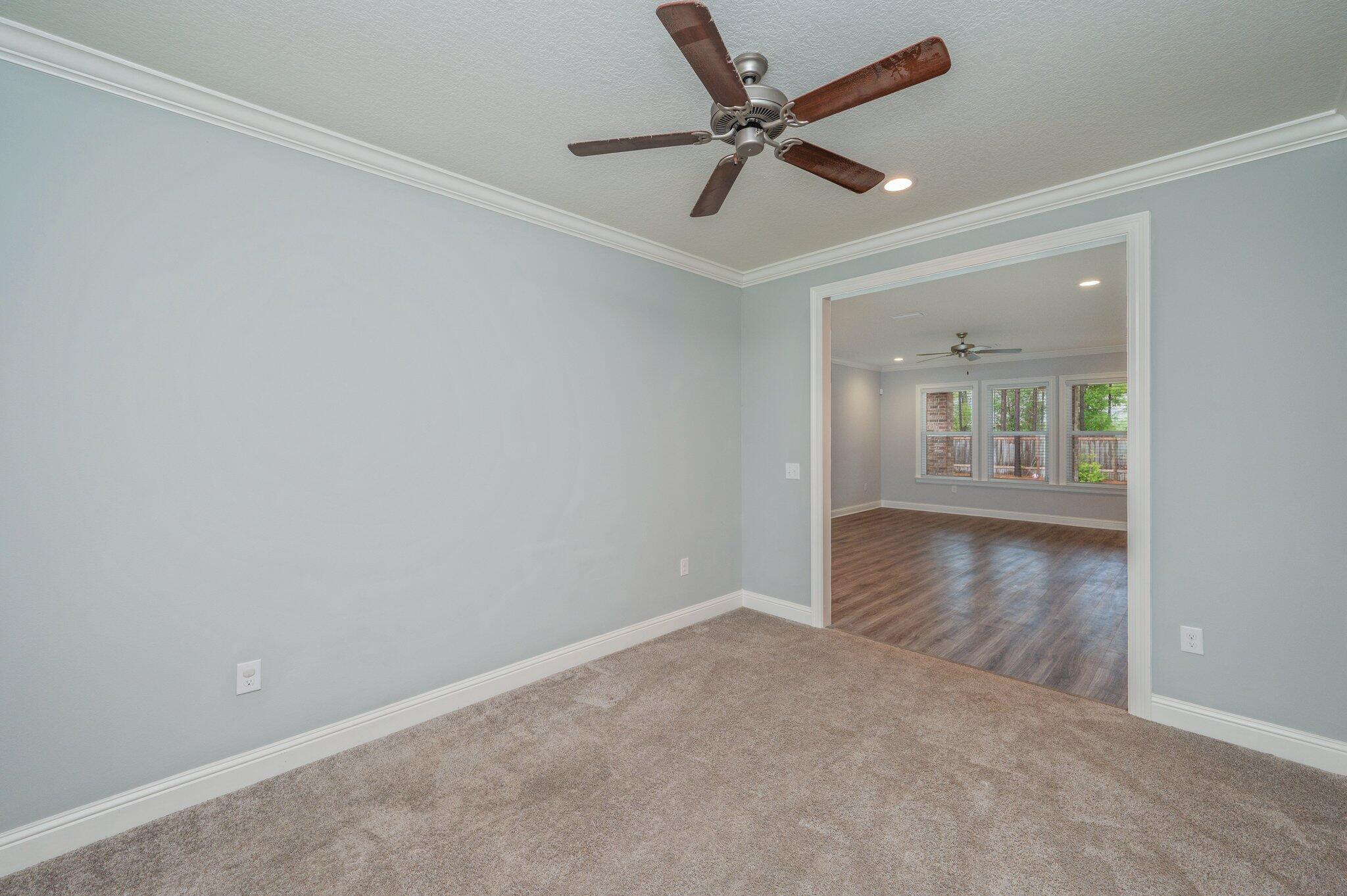 125 Perimeter Place Freeport, FL 32439 - Photo 11 of 26 an empty room with wooden floor and windows