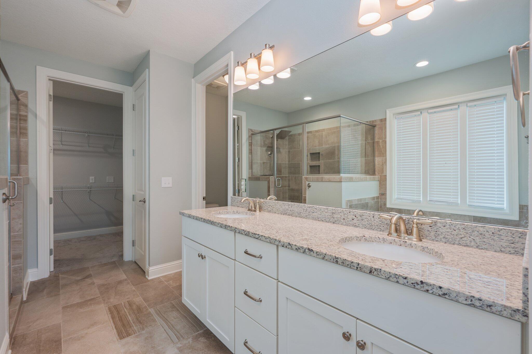 125 Perimeter Place Freeport, FL 32439 - Photo 13 of 26 a bathroom with a granite countertop double vanity sink mirror and shower