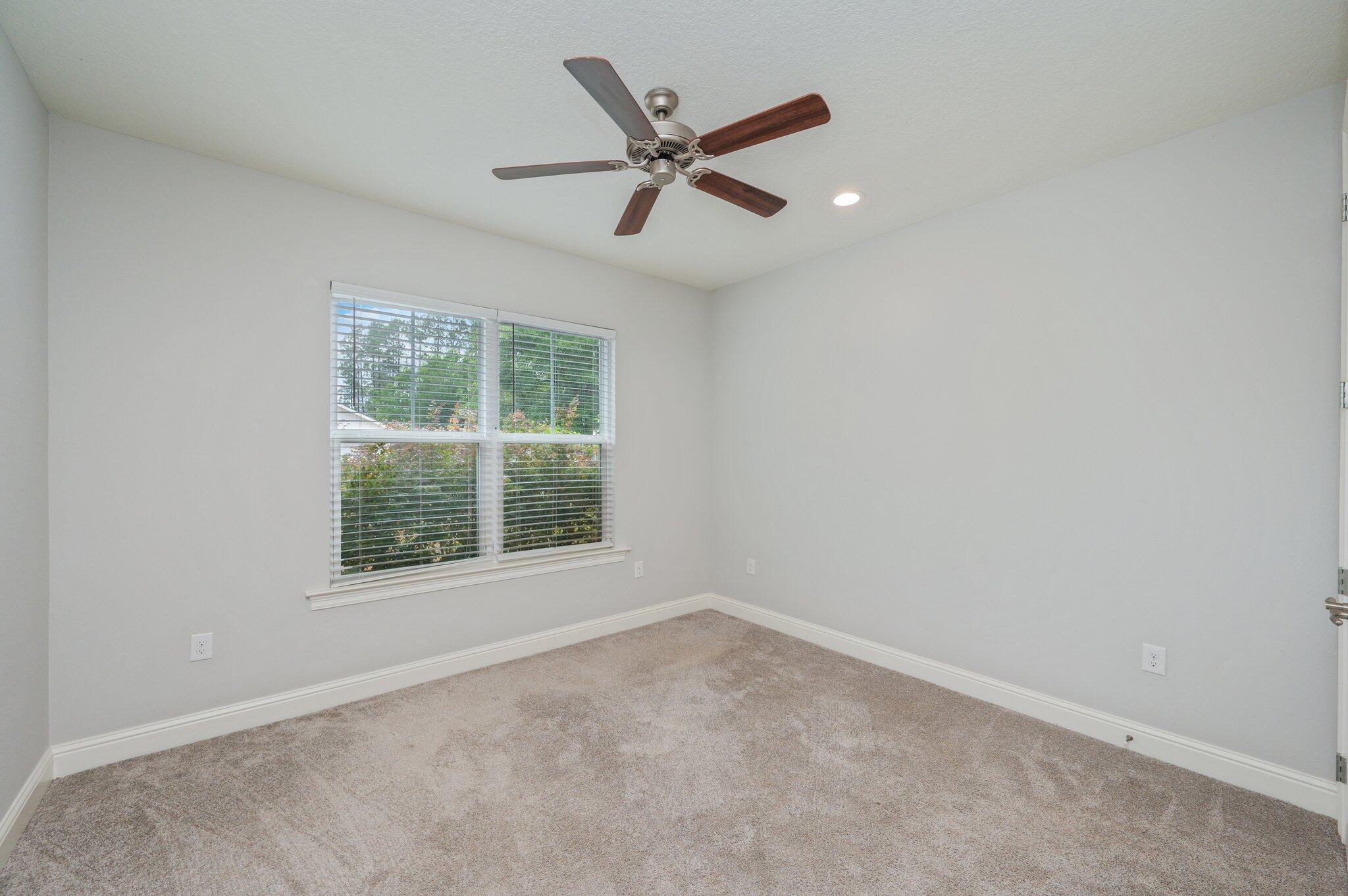 125 Perimeter Place Freeport, FL 32439 - Photo 17 of 26 an empty room with a window and a ceiling fan