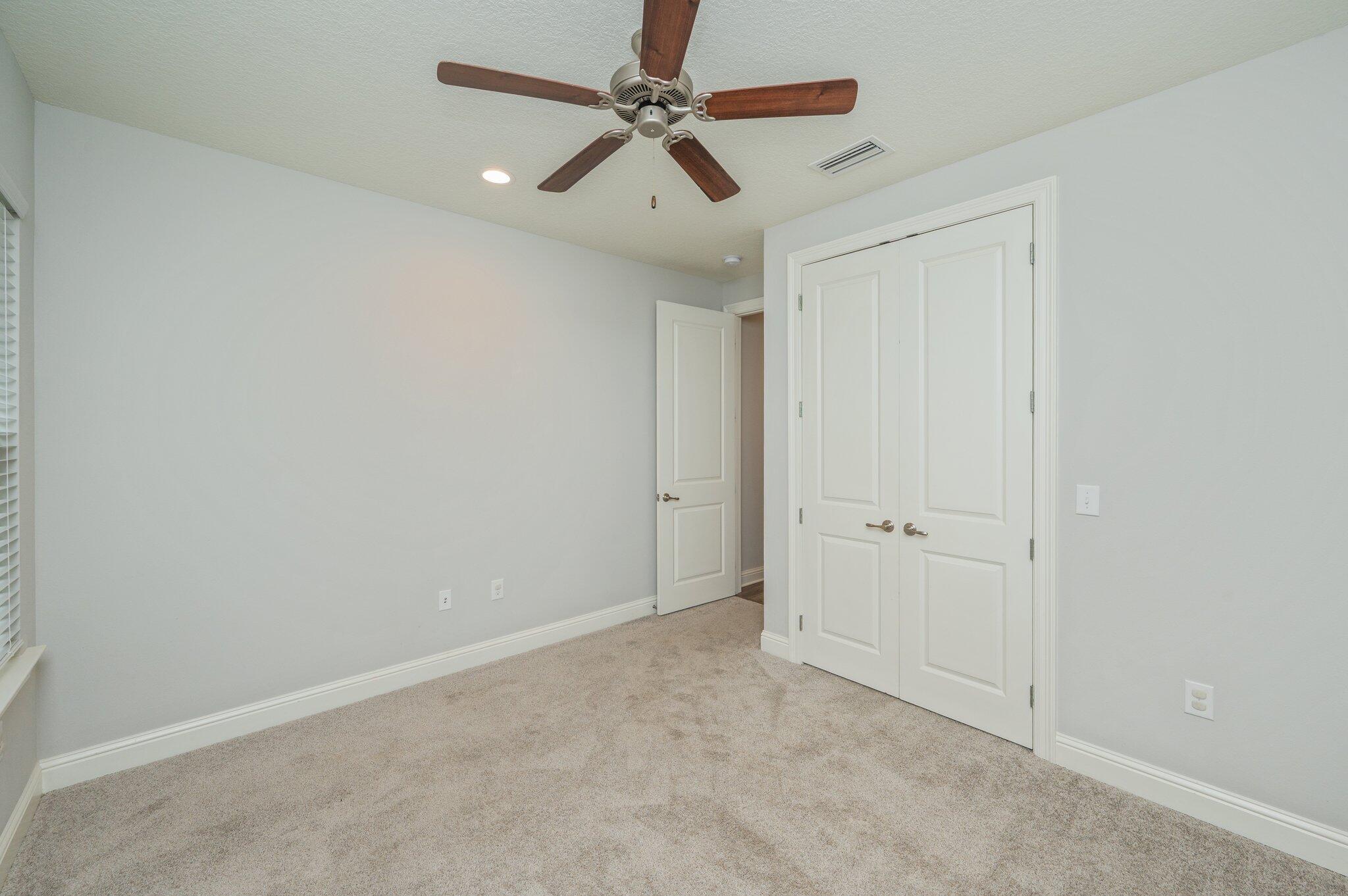 125 Perimeter Place Freeport, FL 32439 - Photo 23 of 26 an empty room with windows and fan
