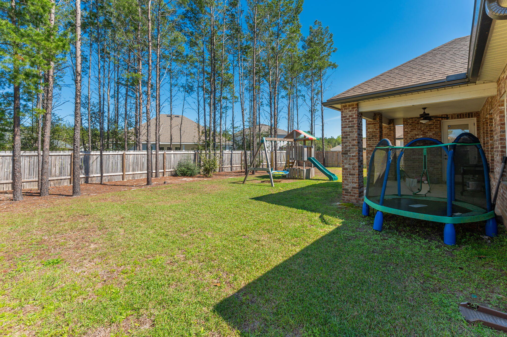 125 Perimeter Place Freeport, FL 32439 - Photo 24 of 26 a view of an house with backyard and a slide
