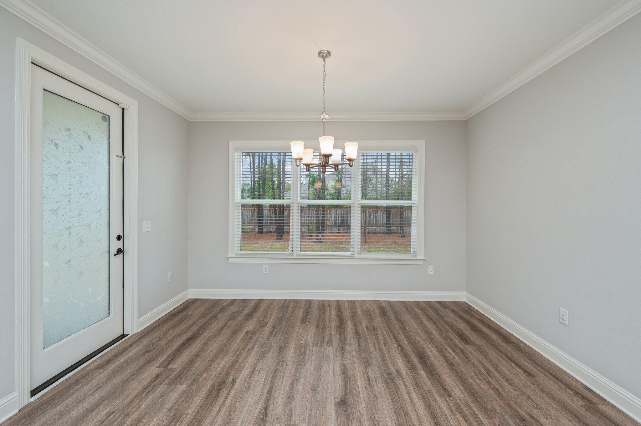 125 Perimeter Place Freeport, FL 32439 - Photo 8 of 26 a view of empty room with wooden floor and fan
