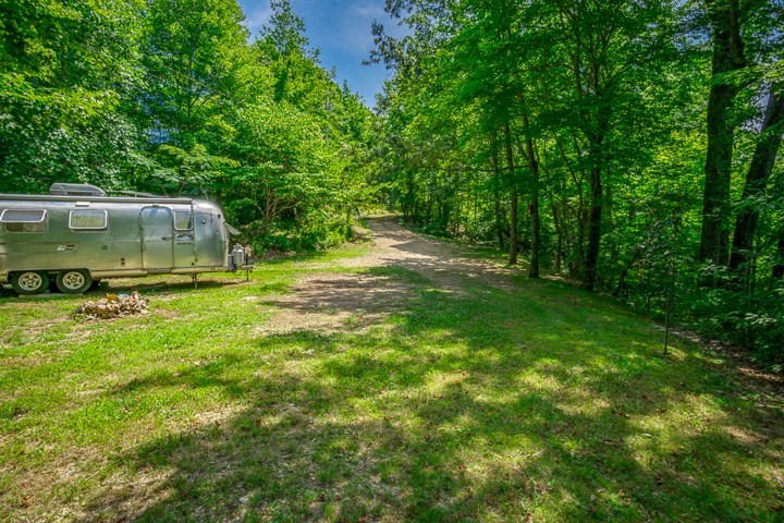 914 Ford Road Baxter, TN 38544 - Photo 11 of 21 a backyard of a house with trees and wooden fence