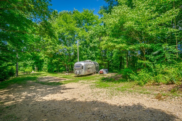 914 Ford Road Baxter, TN 38544 - Photo 19 of 21 a backyard of a house with barbeque oven table and chairs
