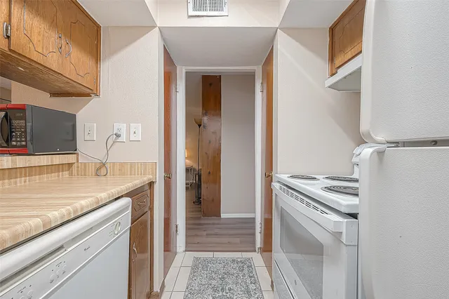 a kitchen with a sink stove and refrigerator