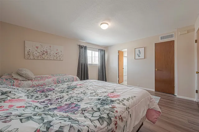 a bedroom with a large bed and closet