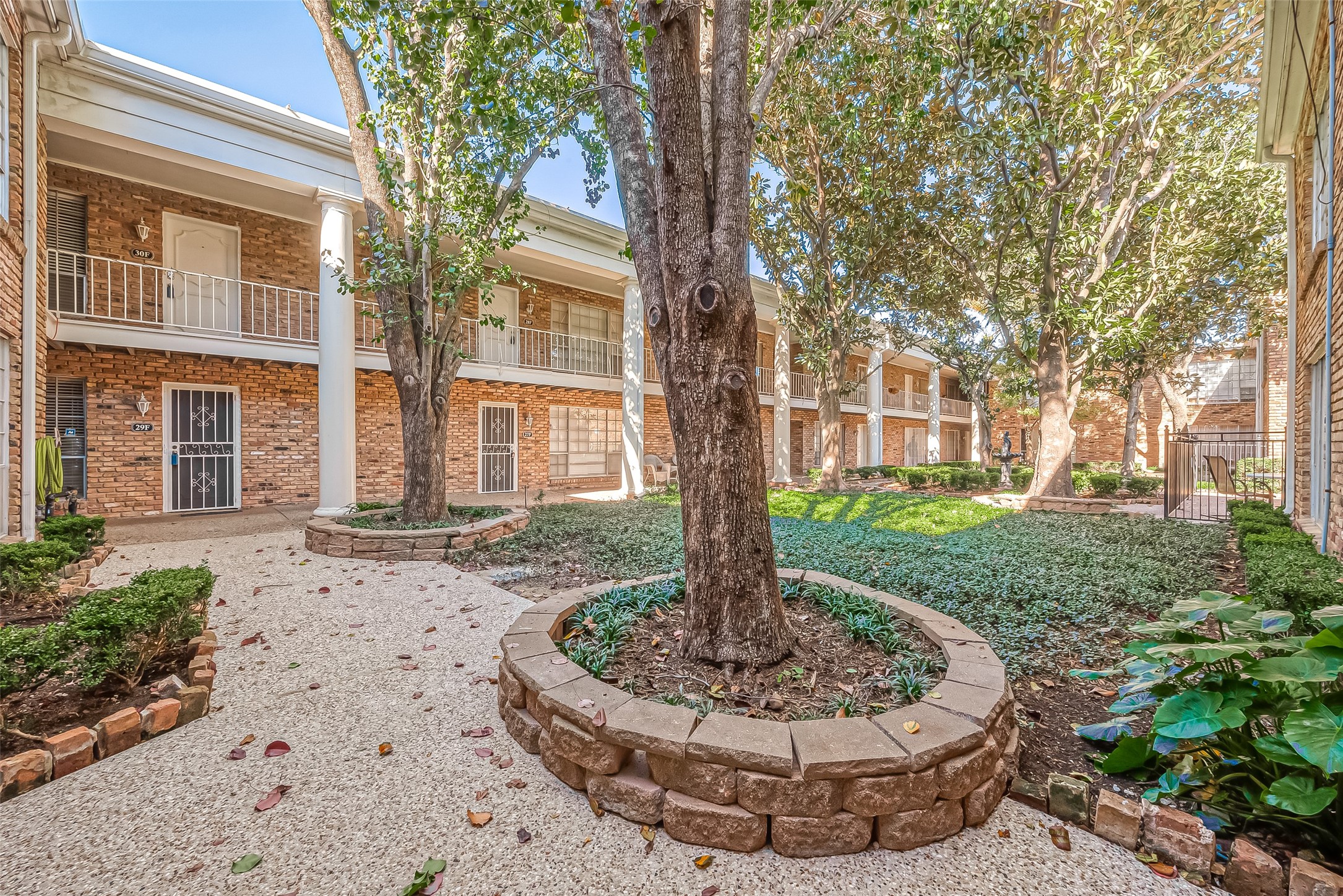 2201 Fountain View Drive, Unit 30 Houston, TX 77057 - Photo 26 of 30 a wooden bench sitting in front of a house