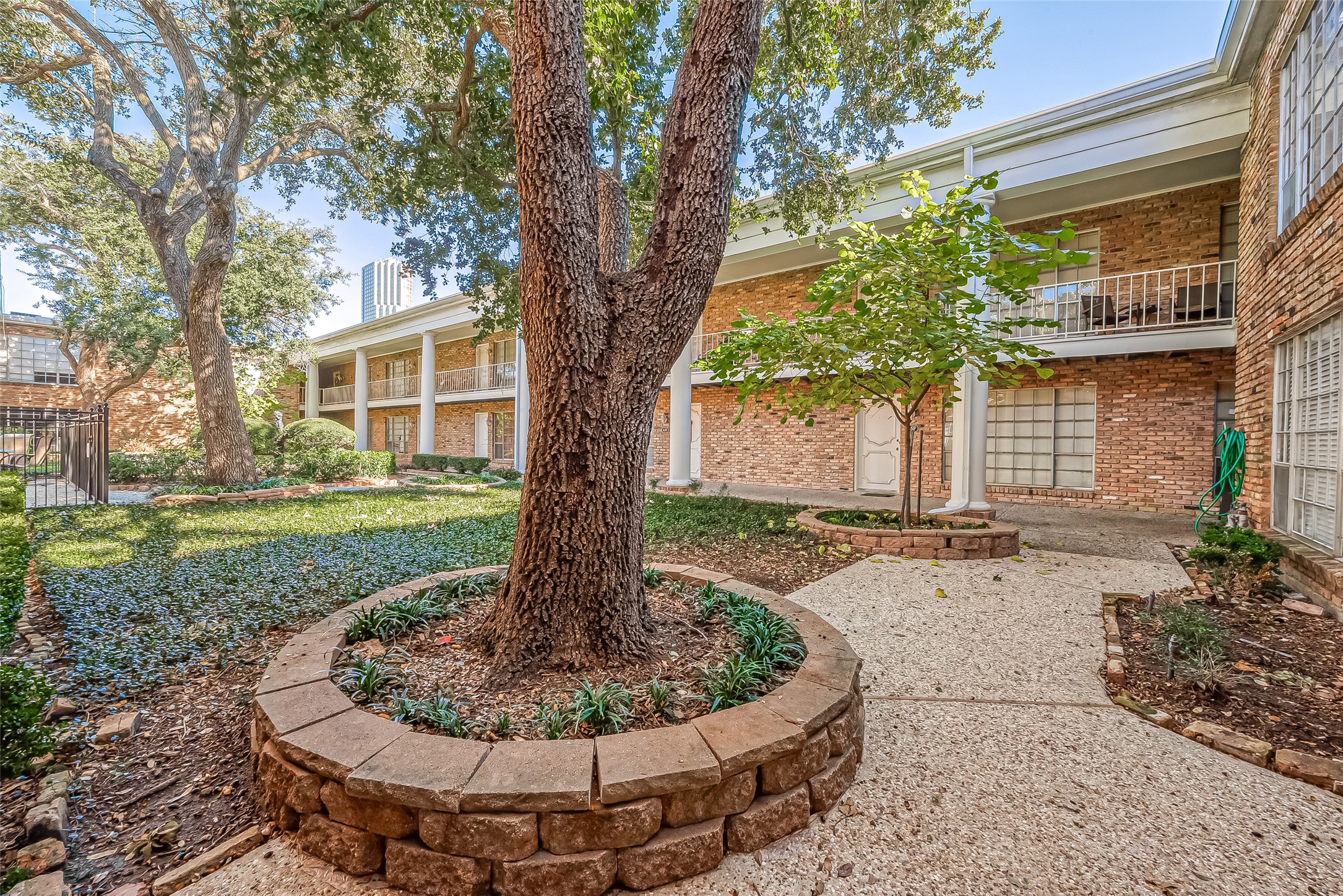 2201 Fountain View Drive, Unit 30 Houston, TX 77057 - Photo 27 of 30 a view of a house with a yard fire pit and a large tree