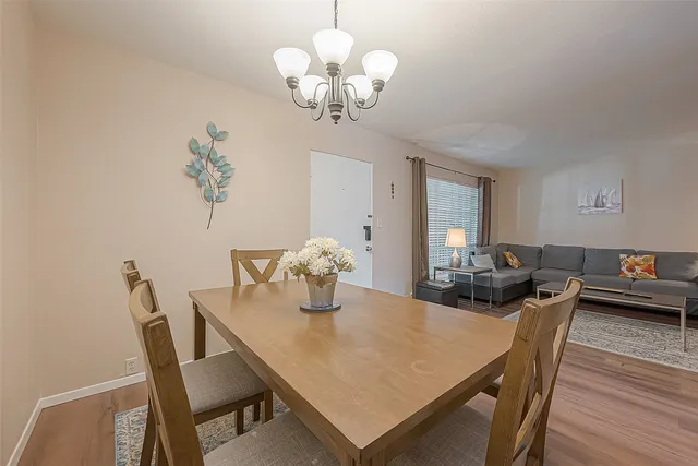 a view of a dining room with furniture wooden floor and chandelier