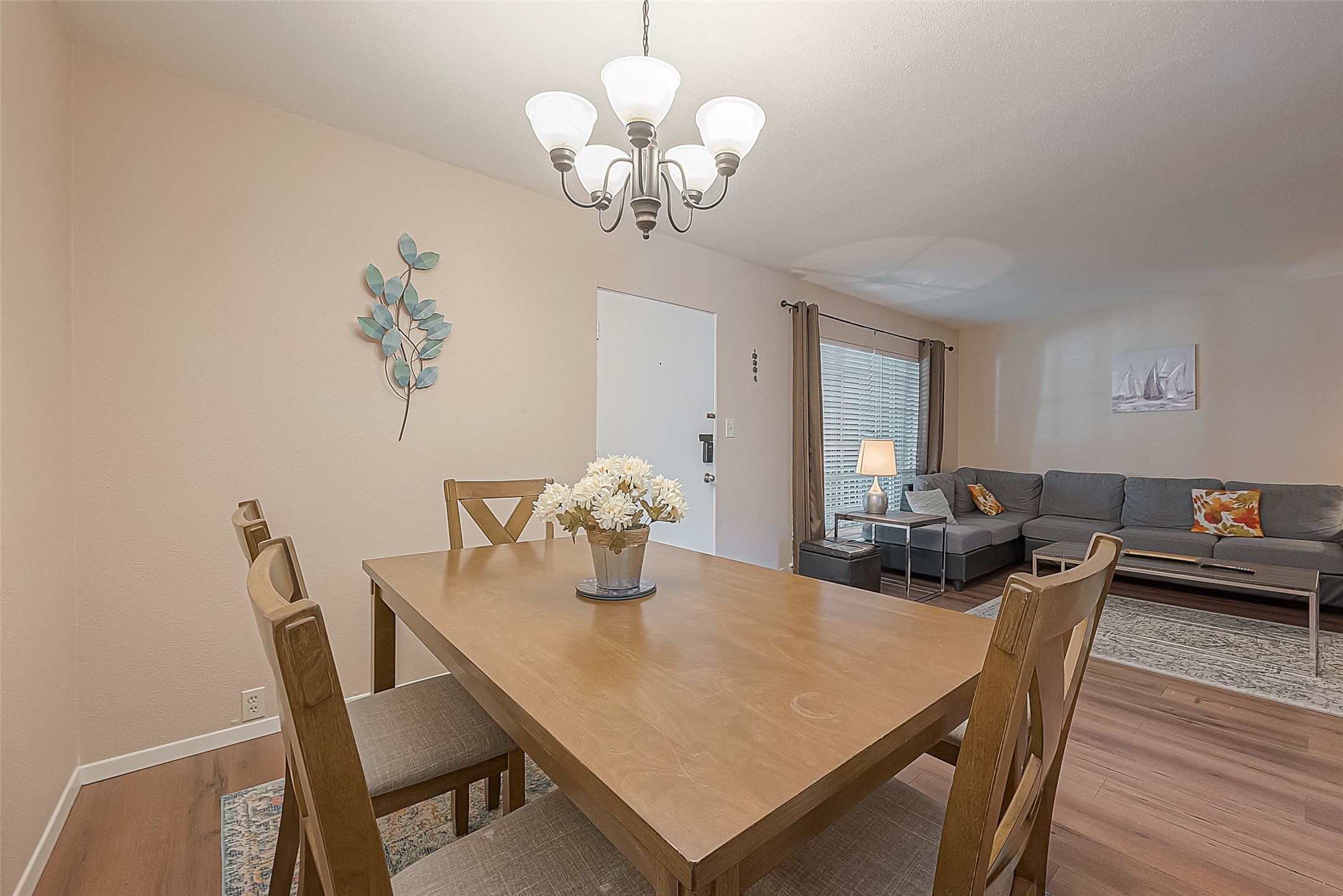 2201 Fountain View Drive, Unit 30 Houston, TX 77057 - Photo 5 of 30 a view of a dining room with furniture wooden floor and chandelier
