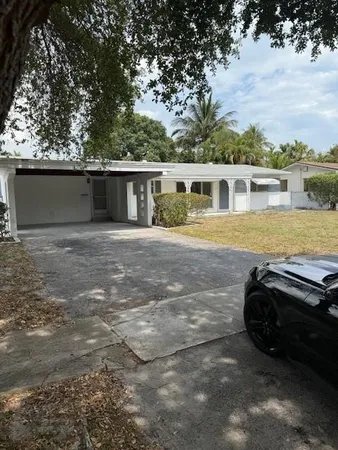 a view of a house with backyard and lake view