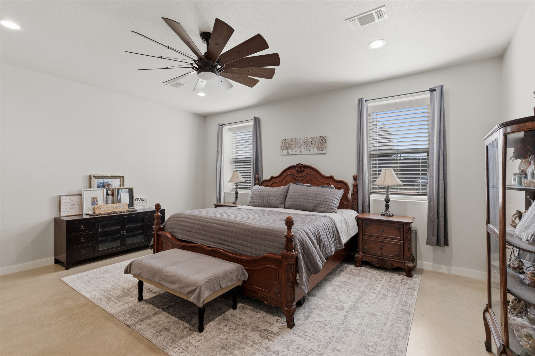 764 Stubbs Road Johnson City, TX 78636 - Photo 22 of 29 Recessed lighting and a unique ceiling fan enhance this cozy bedroom, offering comfort and style.