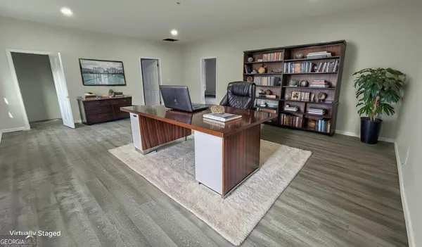 a living room with furniture and a book shelf