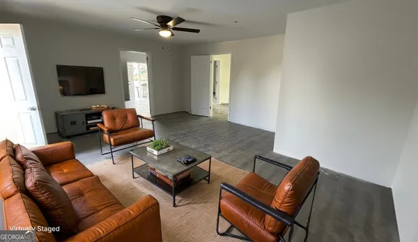 a living room with furniture and a flat screen tv