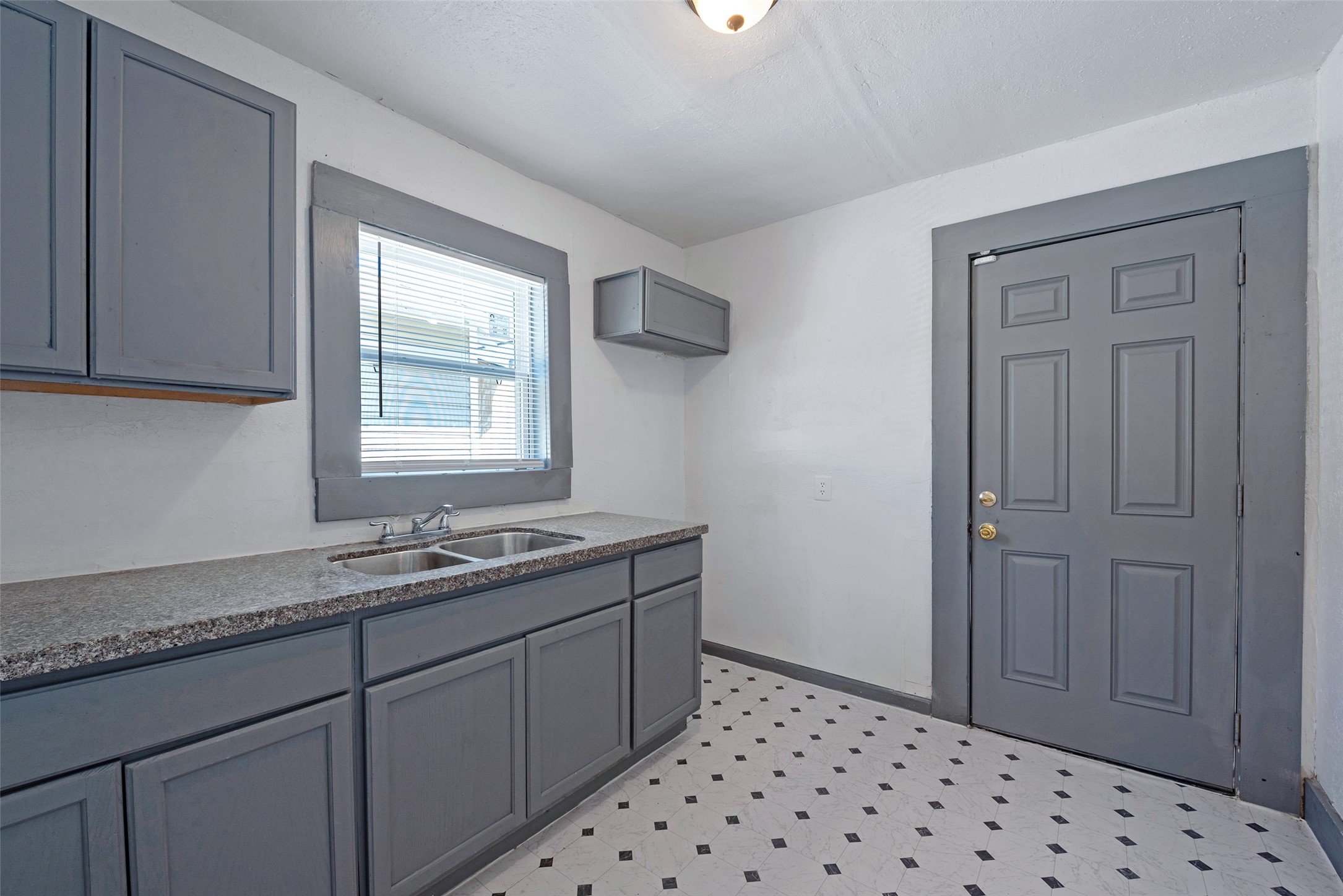 2217 Stevens Street Houston, TX 77026 - Photo 17 of 19 a bathroom with a sink a vanity and a window