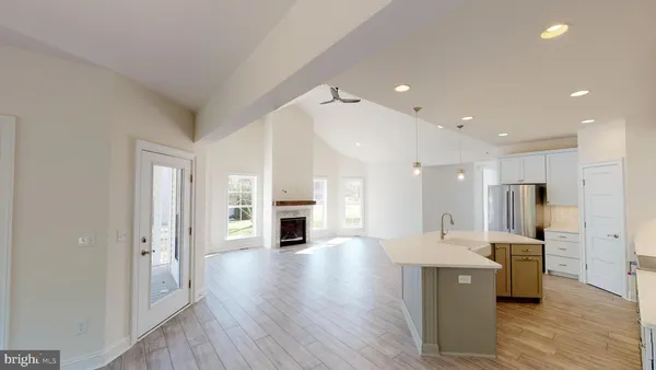 a open kitchen with white cabinets and stainless steel appliances