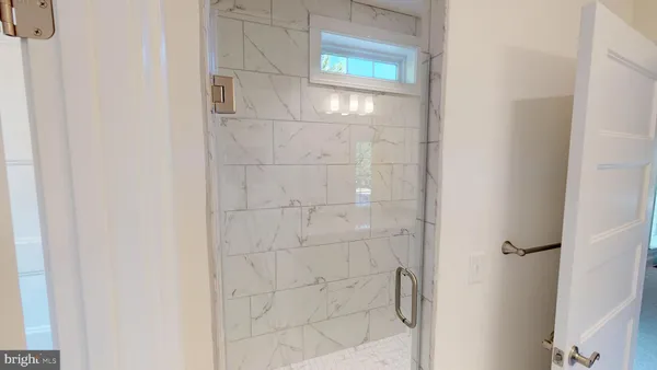 a bathroom with a glass door shower